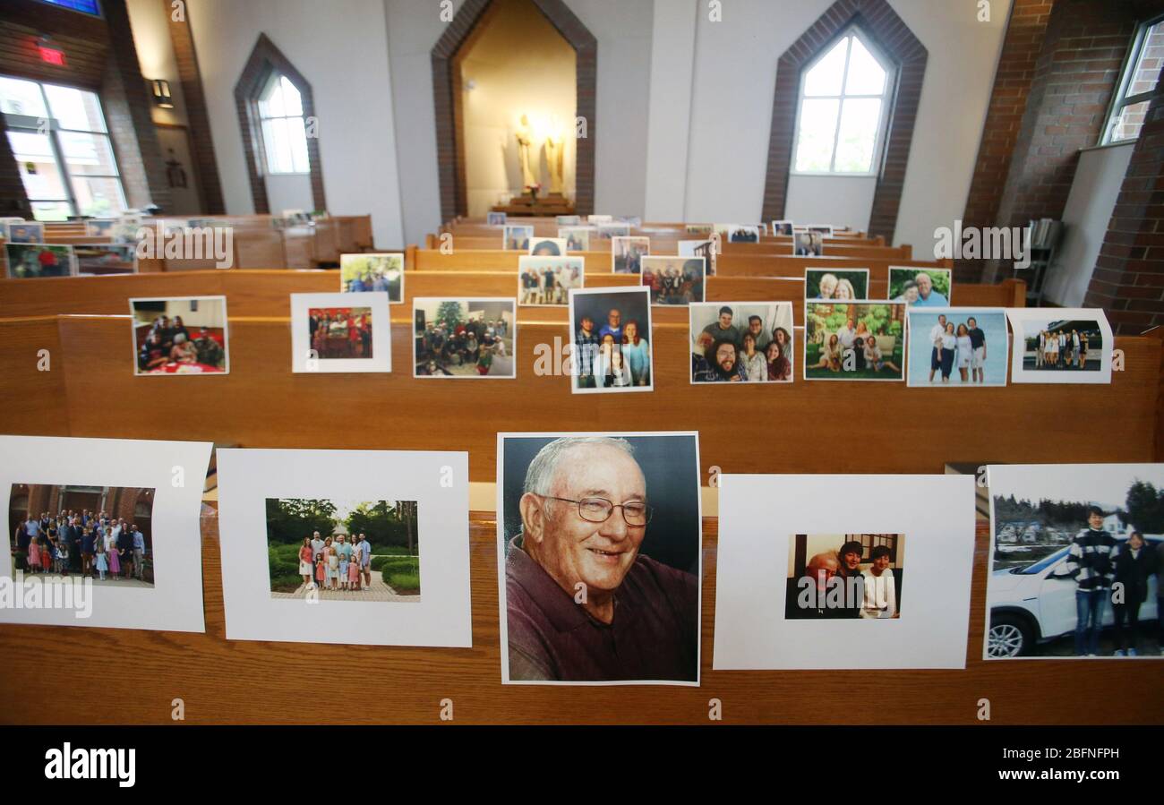 Maryland Heights, United States. 19th Apr, 2020. Photos of parishioners wait for the start of Rev. Bob Evans Sunday service at the Holy Spirit Catholic Church in Maryland Heights, Missouri on Sunday, April 19, 2020. Since members cannot attend in person because of the Coronavirus pandemic, Evans asked for his church to send in photos of themselves receiving over 500 photos from his 1500 membership. The photos are taped to the pews where the family sits, while he preforms the weekly service via Facebook live. Photo by Bill Greenblatt/UPI Credit: UPI/Alamy Live News Stock Photo