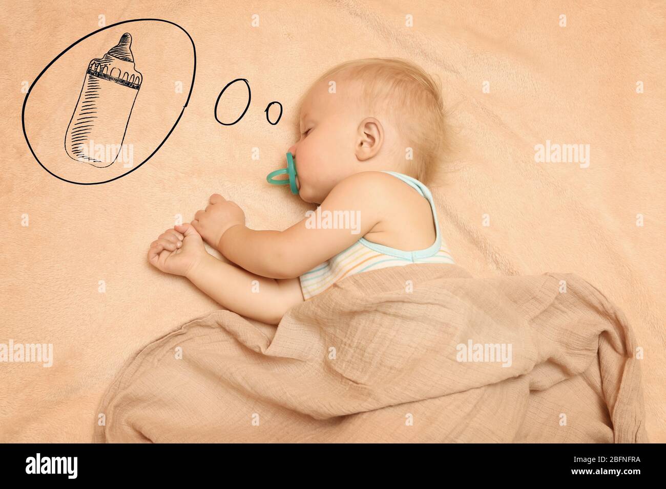 Cute baby sleeping on bed and dreaming of milk Stock Photo Alamy