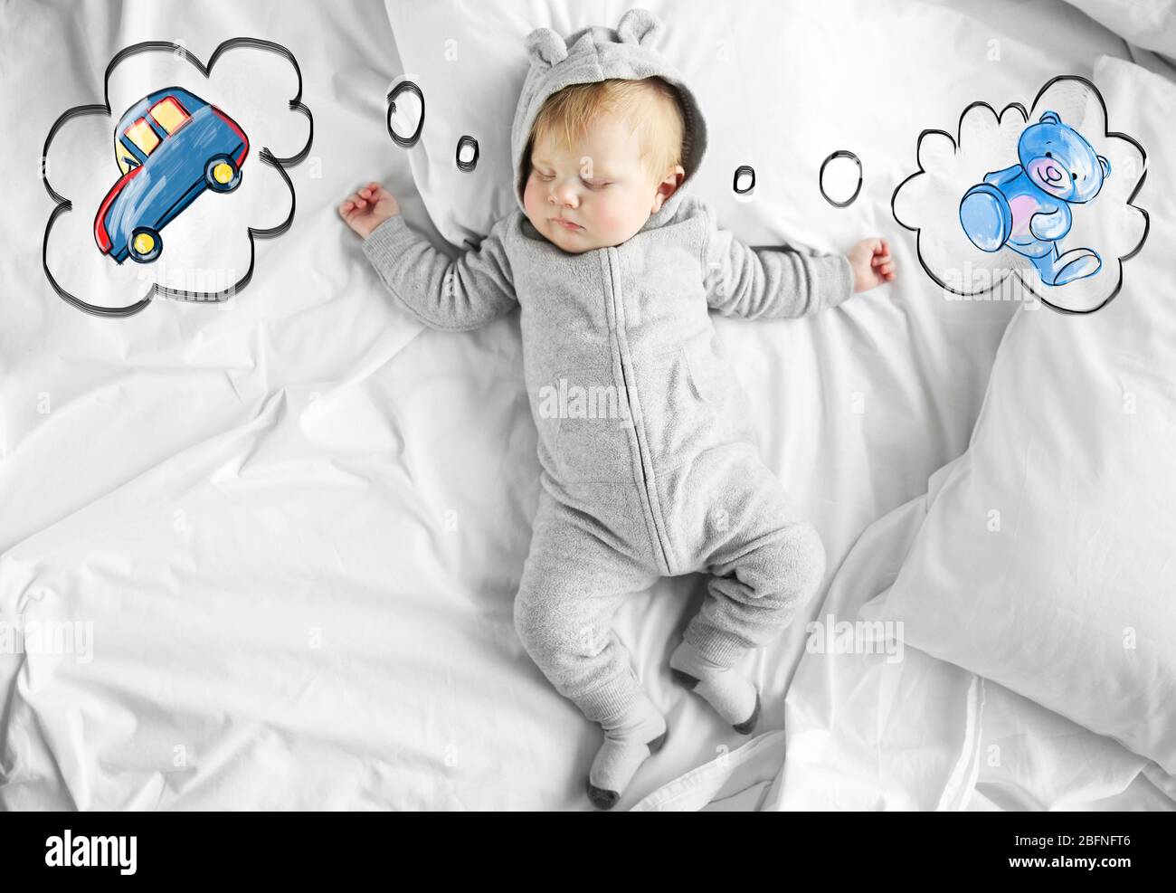 Cute baby sleeping on bed and dreaming of toys Stock Photo Alamy