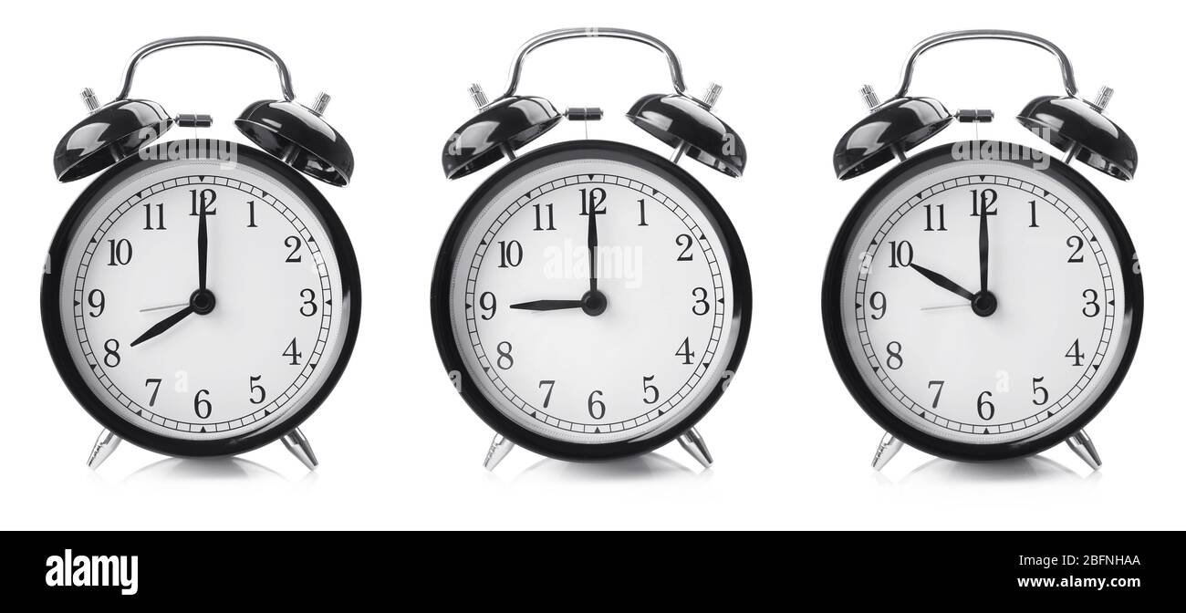 Time change concept. Alarm clocks on white background Stock Photo Alamy