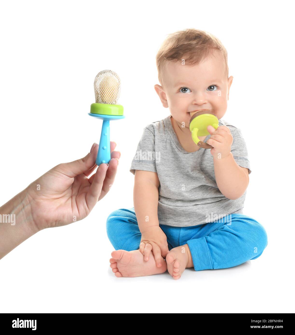 Baby and female hand with nibblers on white background Stock Photo Alamy