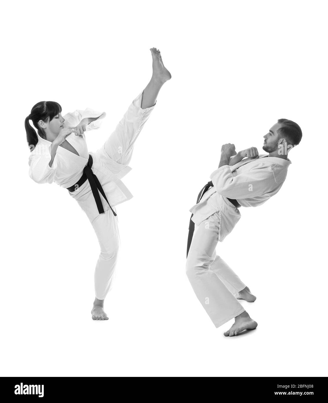 Young people practising karate on white background Stock Photo