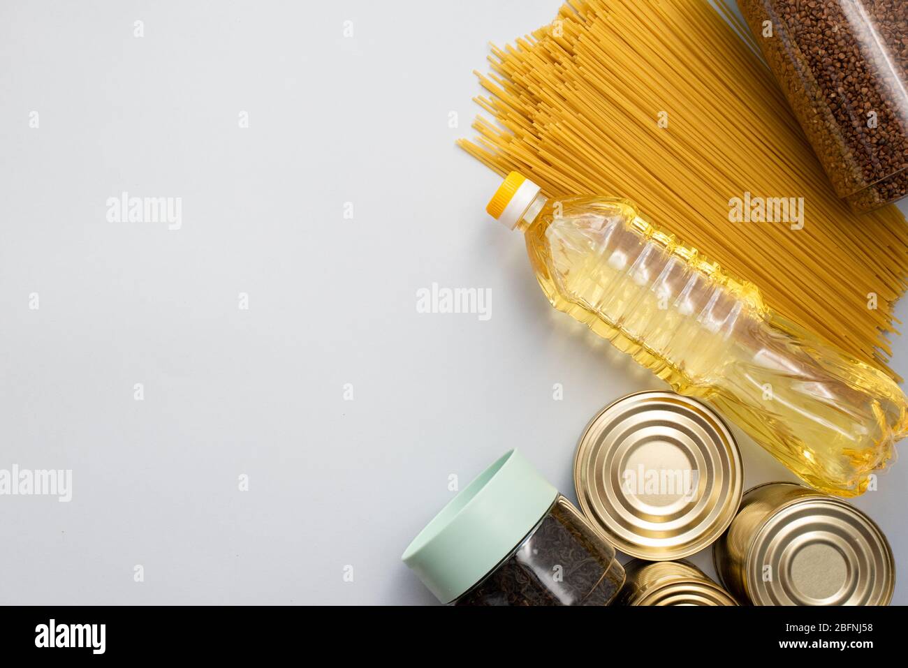 Cereals, various products, canned food, pasta and soap with place for text. Humanitarian assistance during the coronavirus pandemic. Stock of non-peri Stock Photo