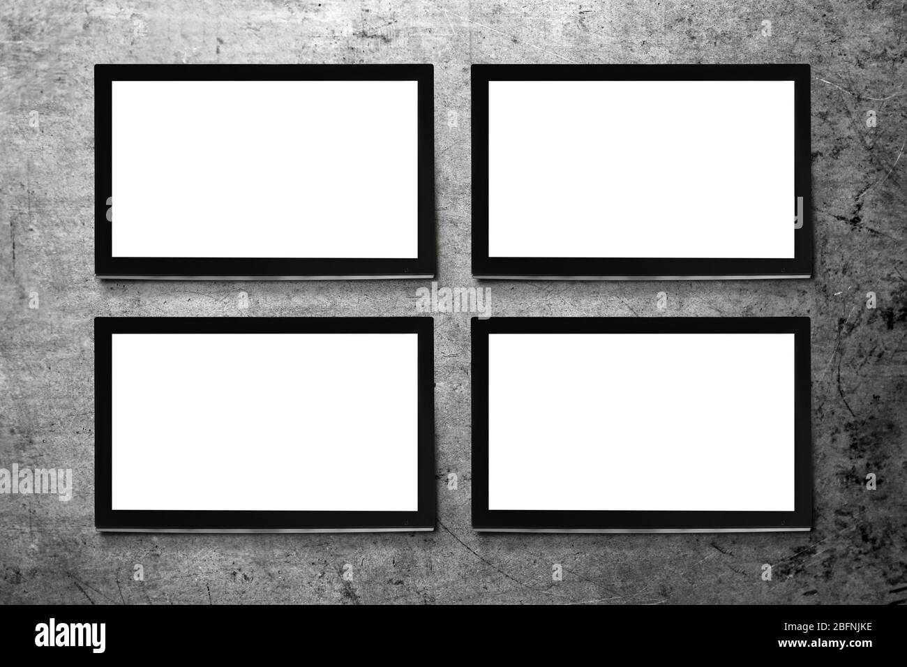 Modern TV screens on grey wall background Stock Photo - Alamy
