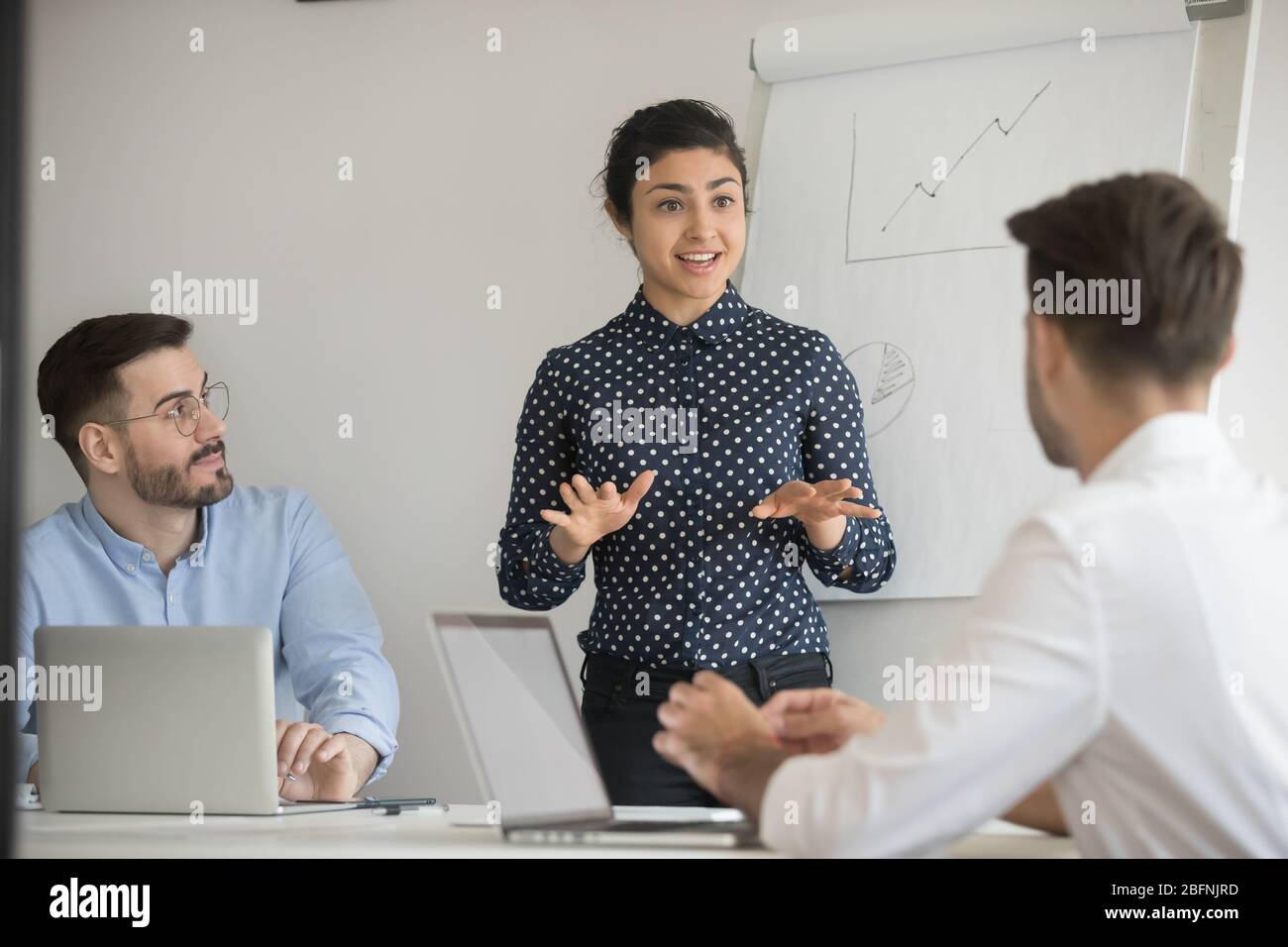 Indian confident business trainer giving presentation to corporate ...
