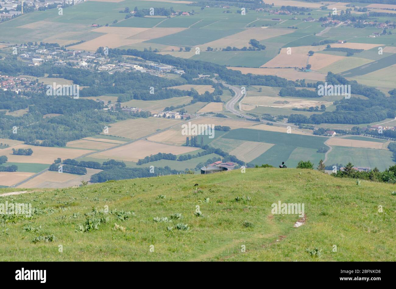 Green mountain landscape during summer season overlooking the Thoiry region in France from Jura Mountains Stock Photo