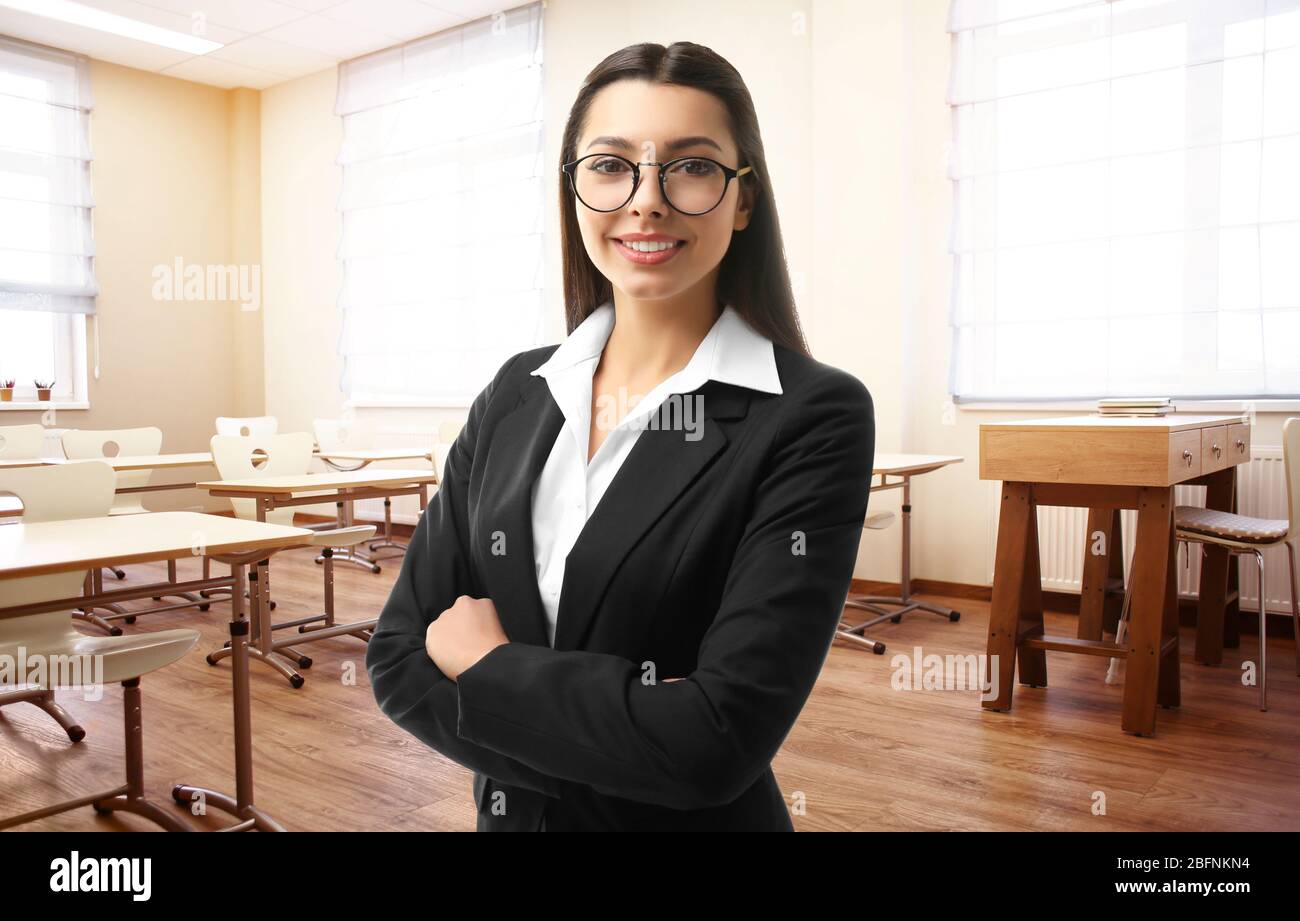 Portrait of young teacher in modern class room at school Stock Photo