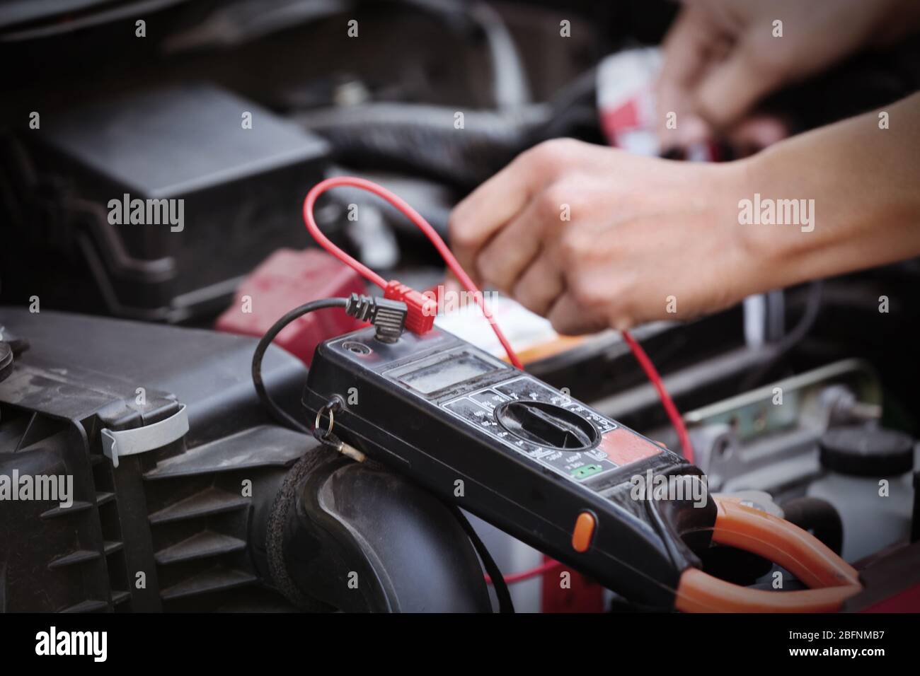 Auto mechanic repairing car in body shop Stock Photo