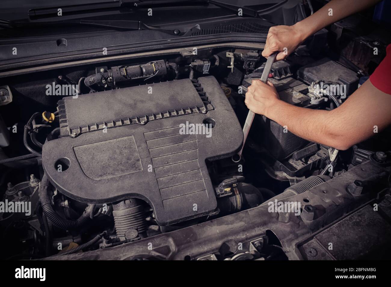 Auto mechanic repairing car in body shop Stock Photo