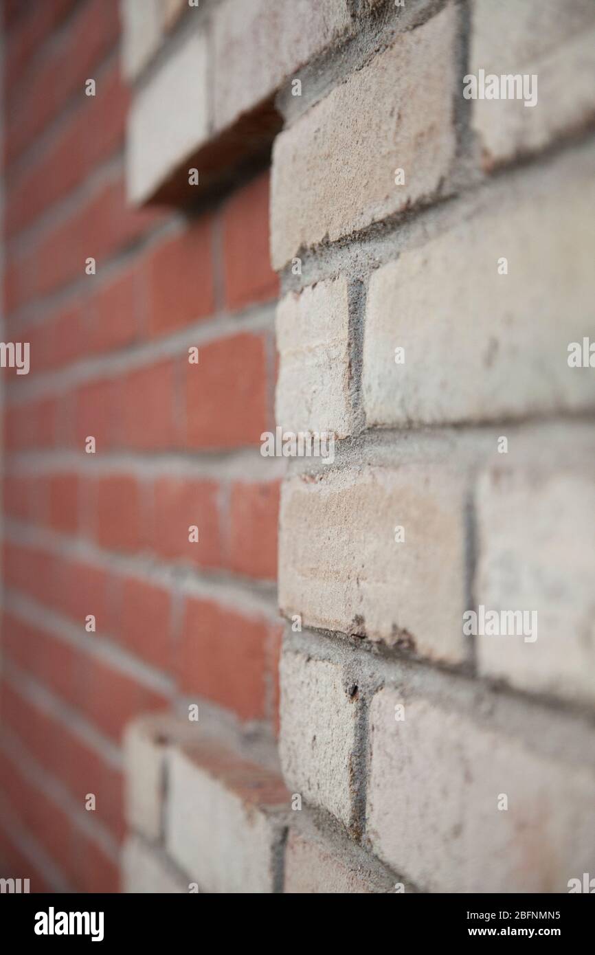 View of an old red and white brick wall with rich colorful grainy