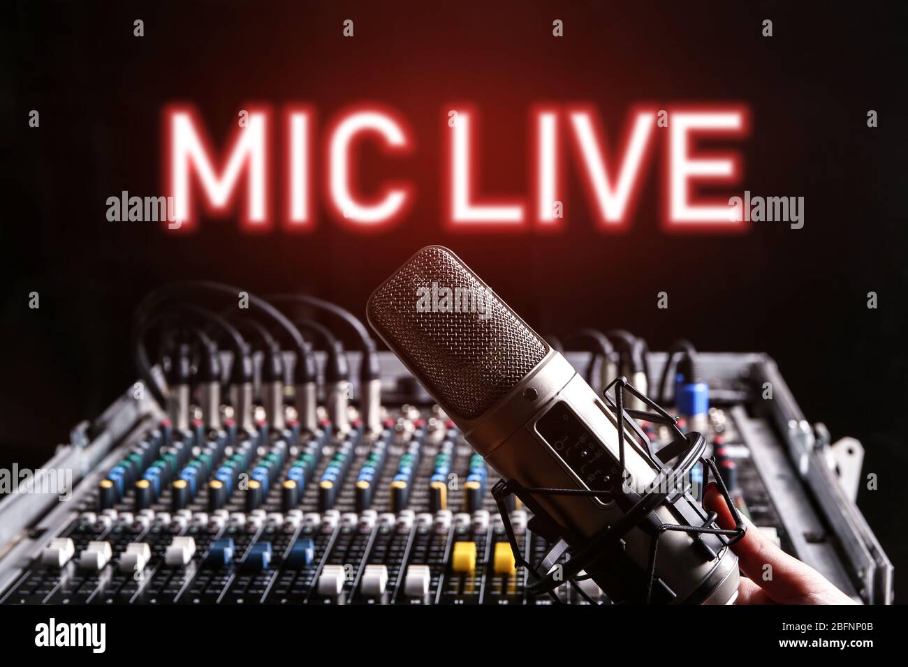 Microphone and mixer for live radio broadcast on black background Stock  Photo - Alamy