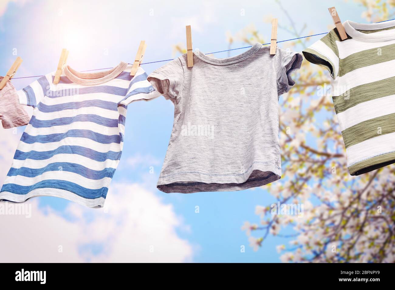 Rope with clean clothes outdoors on laundry day Stock Photo
