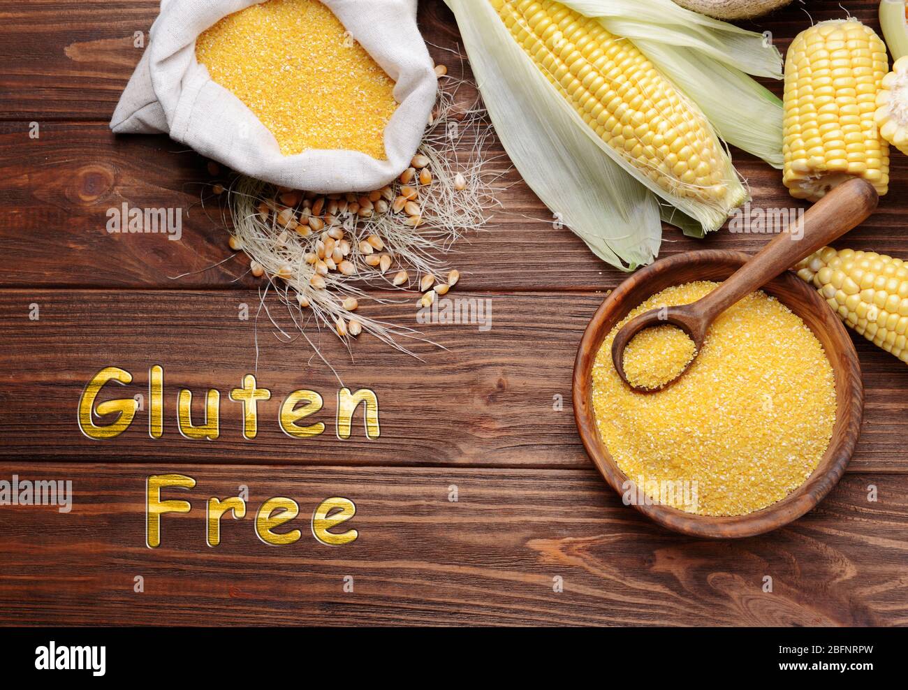 Gluten free food concept. Corn and cornflour on wooden background Stock