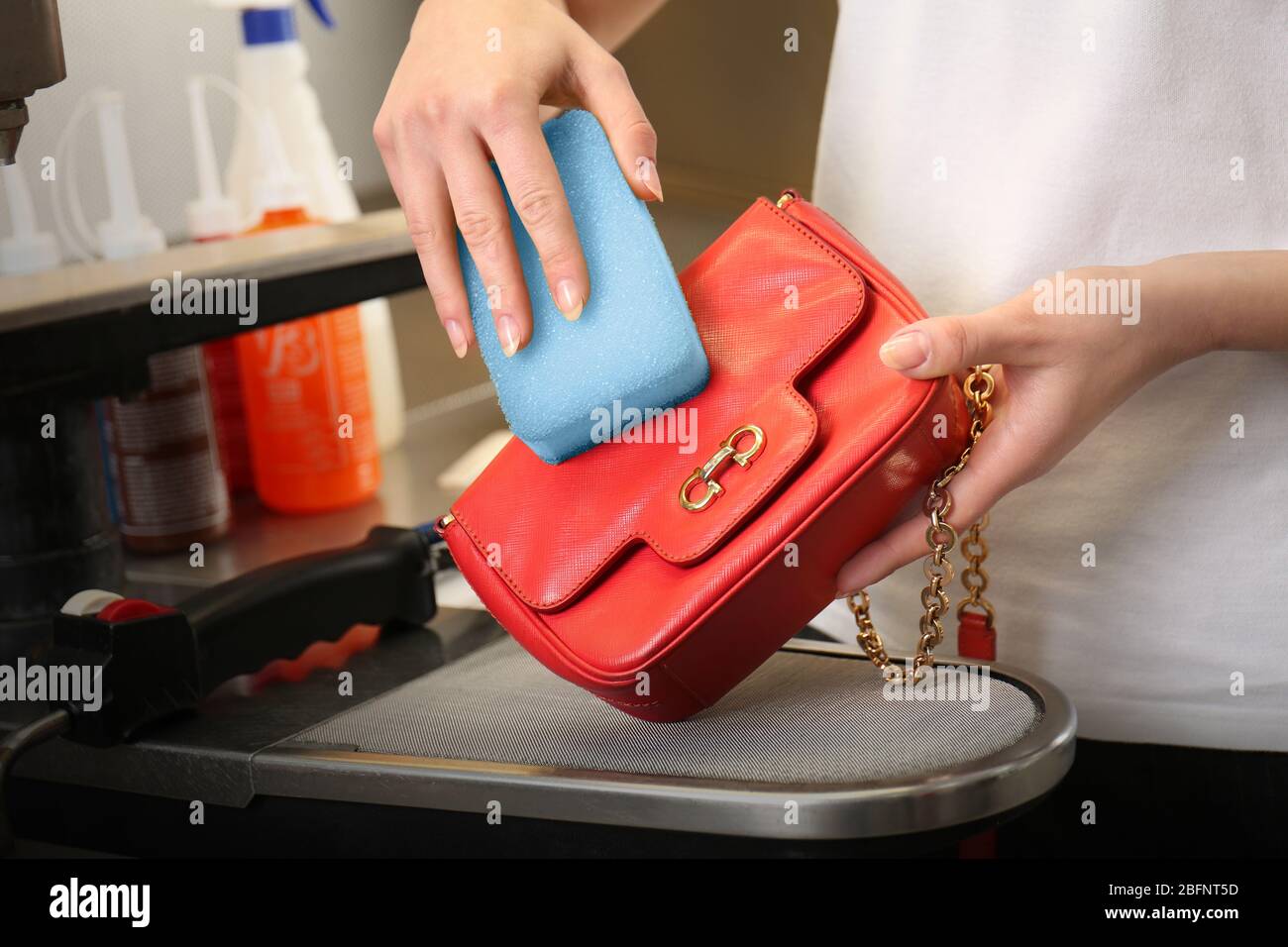 Dry cleaning business concept. Woman washing bag with sponge Stock Photo -  Alamy