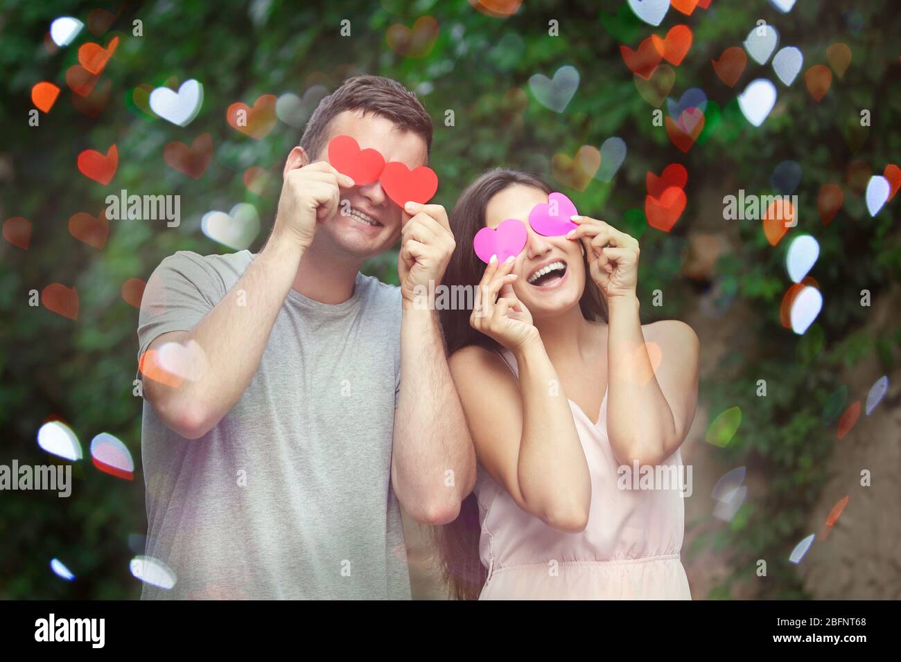 Beautiful young couple having fun in park Stock Photo - Alamy
