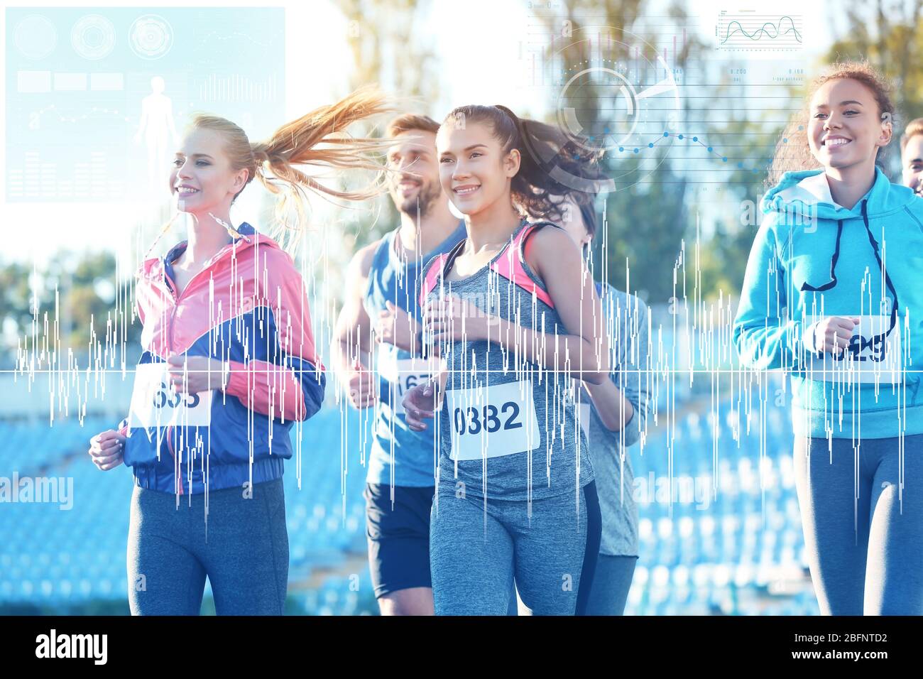 Heart rate monitor concept. Young people running at stadium Stock Photo