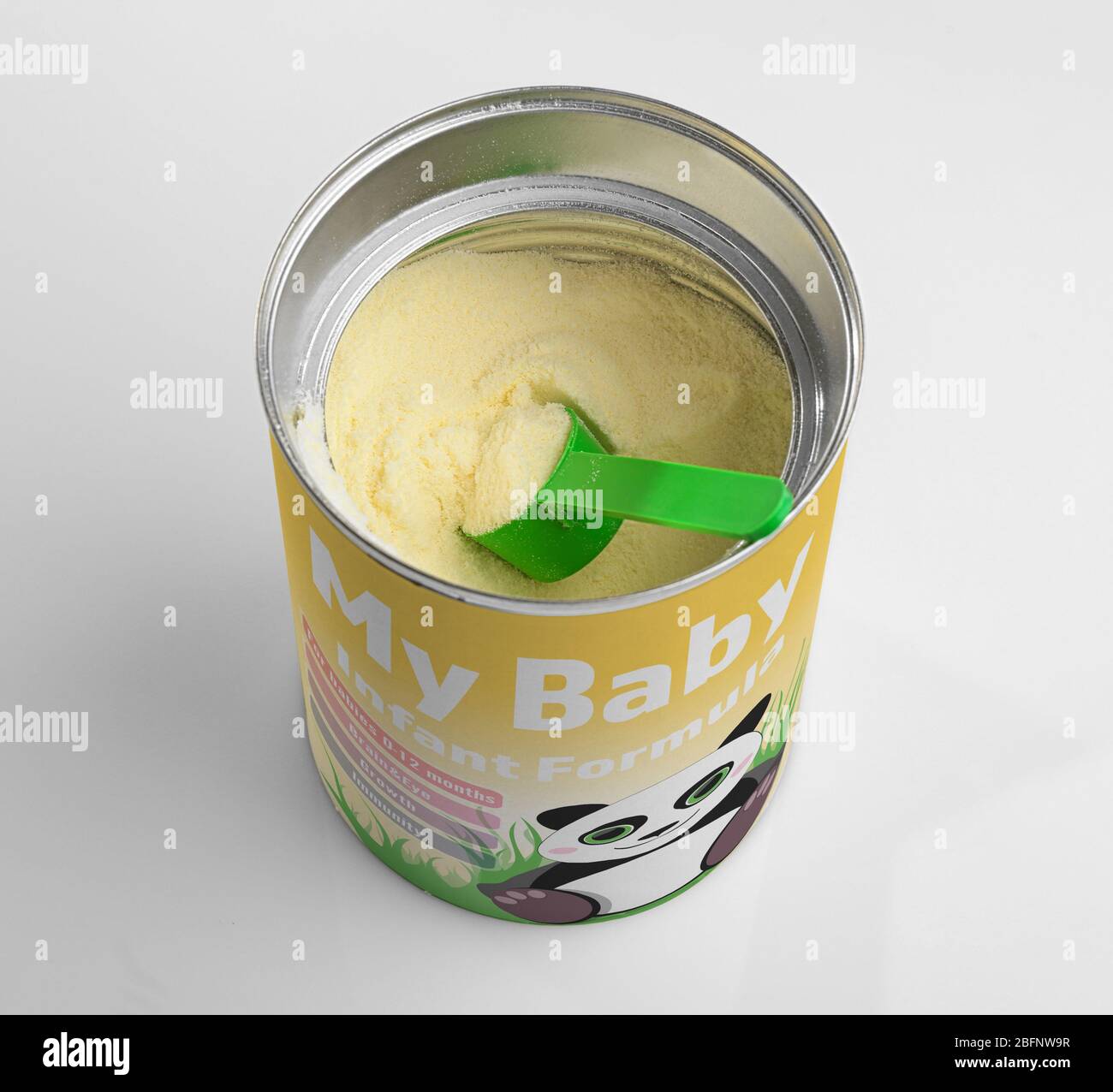 Can and scoop with powdered baby milk formula on light background Stock Photo