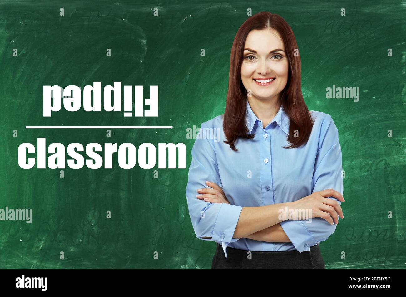 Flipped classroom concept. Teacher on blackboard background Stock Photo