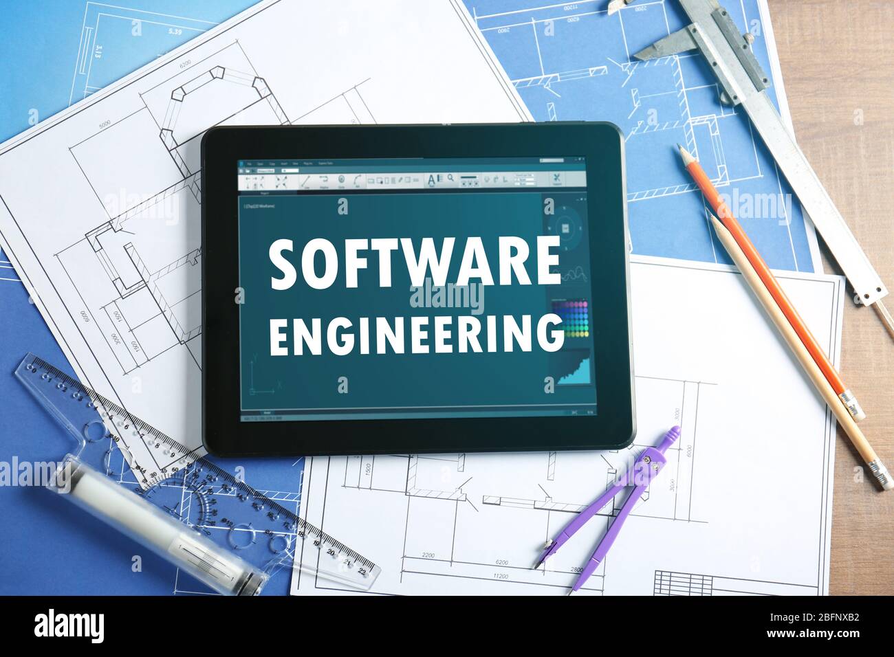 Software engineering concept. Tablet with drawings on table Stock Photo