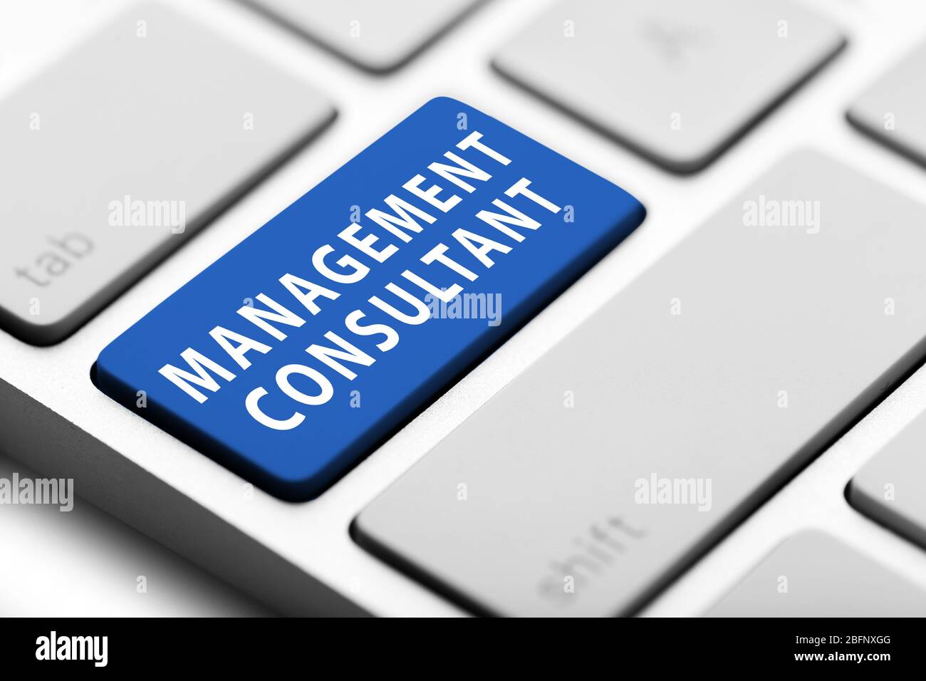 MANAGEMENT CONSULTANT button on keyboard, closeup Stock Photo