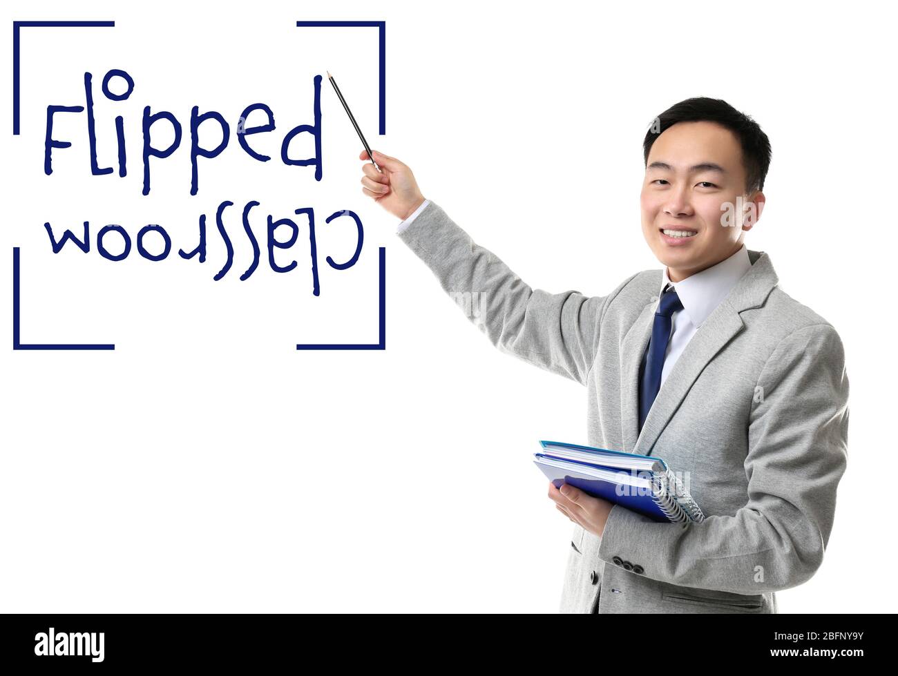 Flipped classroom concept. Young teacher with books on white background Stock Photo