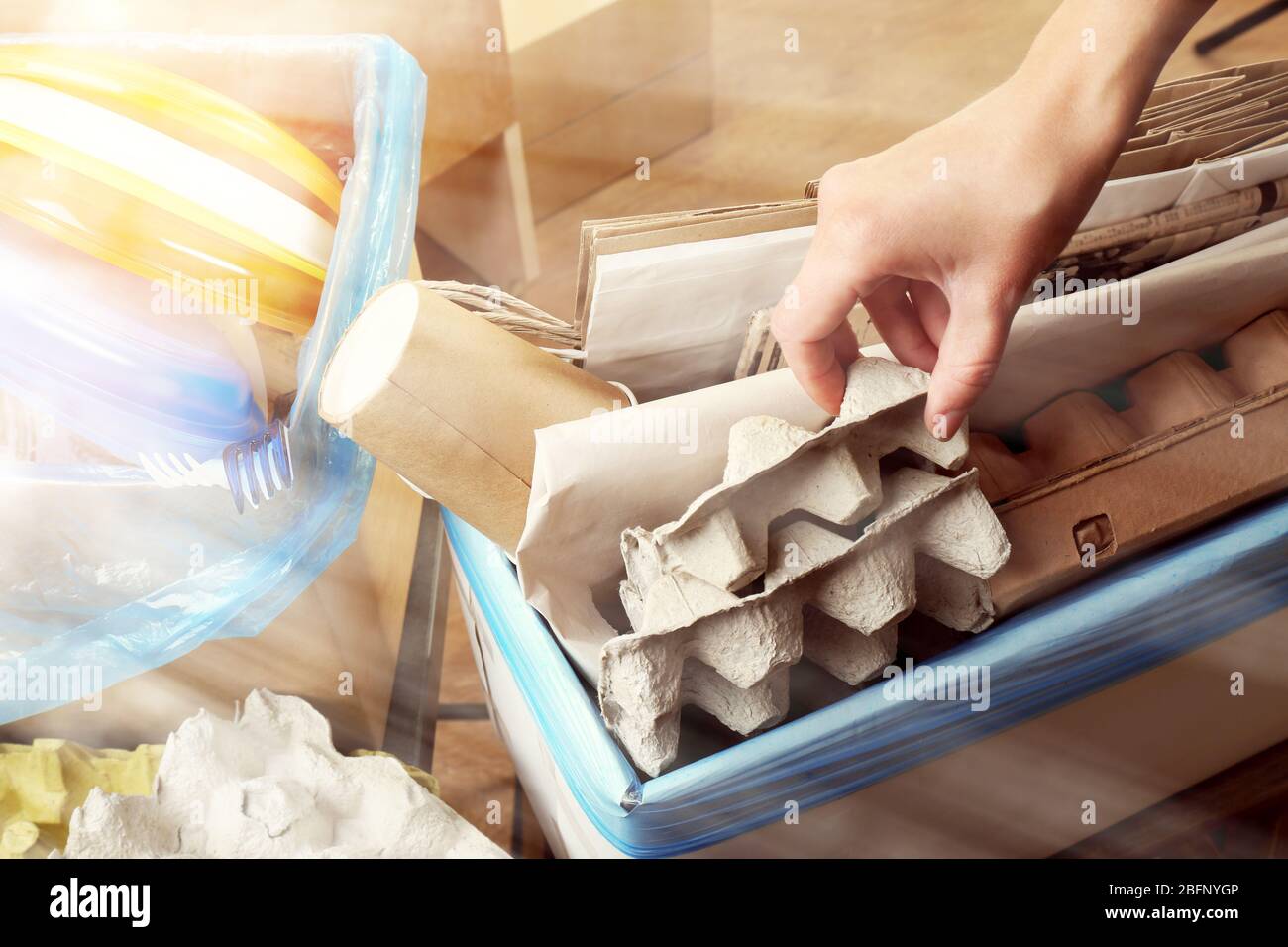 Woman sorting different types of garbage, closeup. Recycling concept ...