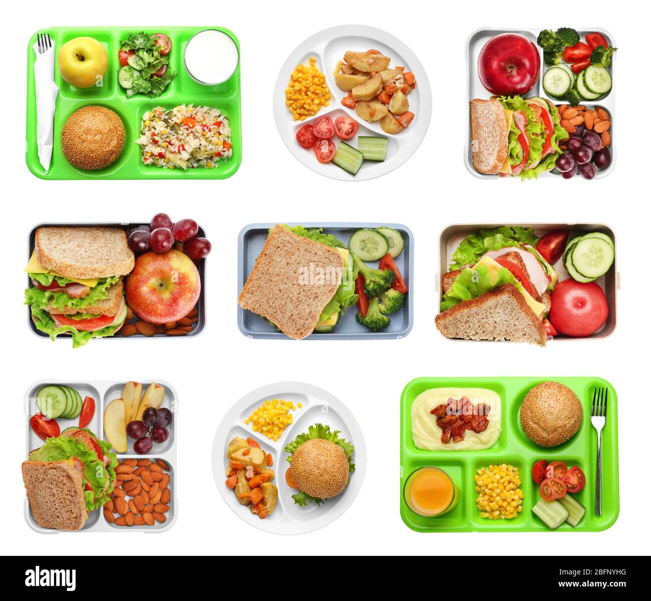 Set of serving trays and boxes with food for school lunch on white
