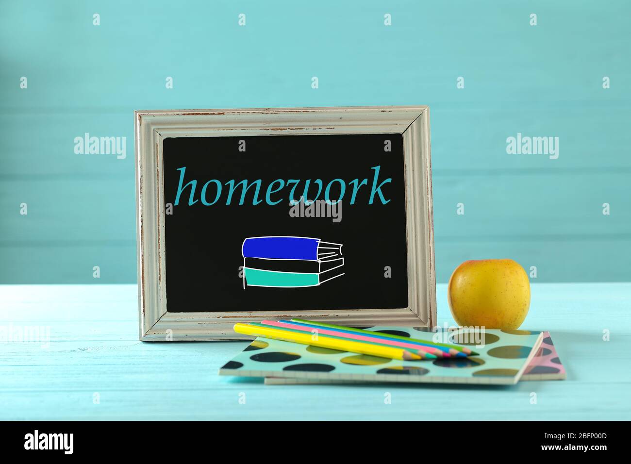 Small chalkboard with word HOMEWORK and school supplies on table Stock ...