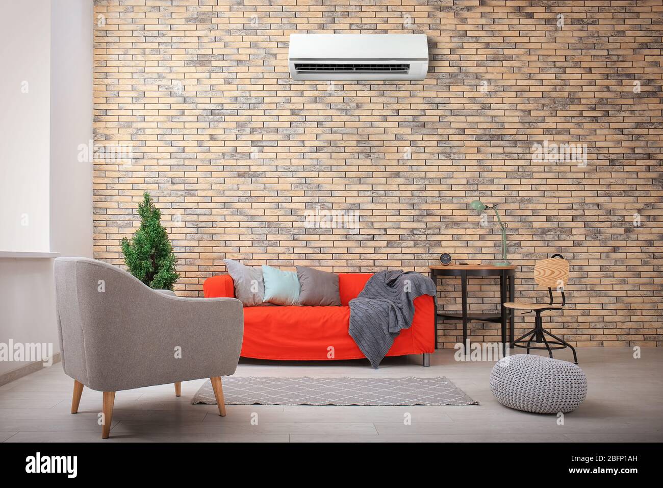 Living room interior with comfortable sofa and air conditioner Stock