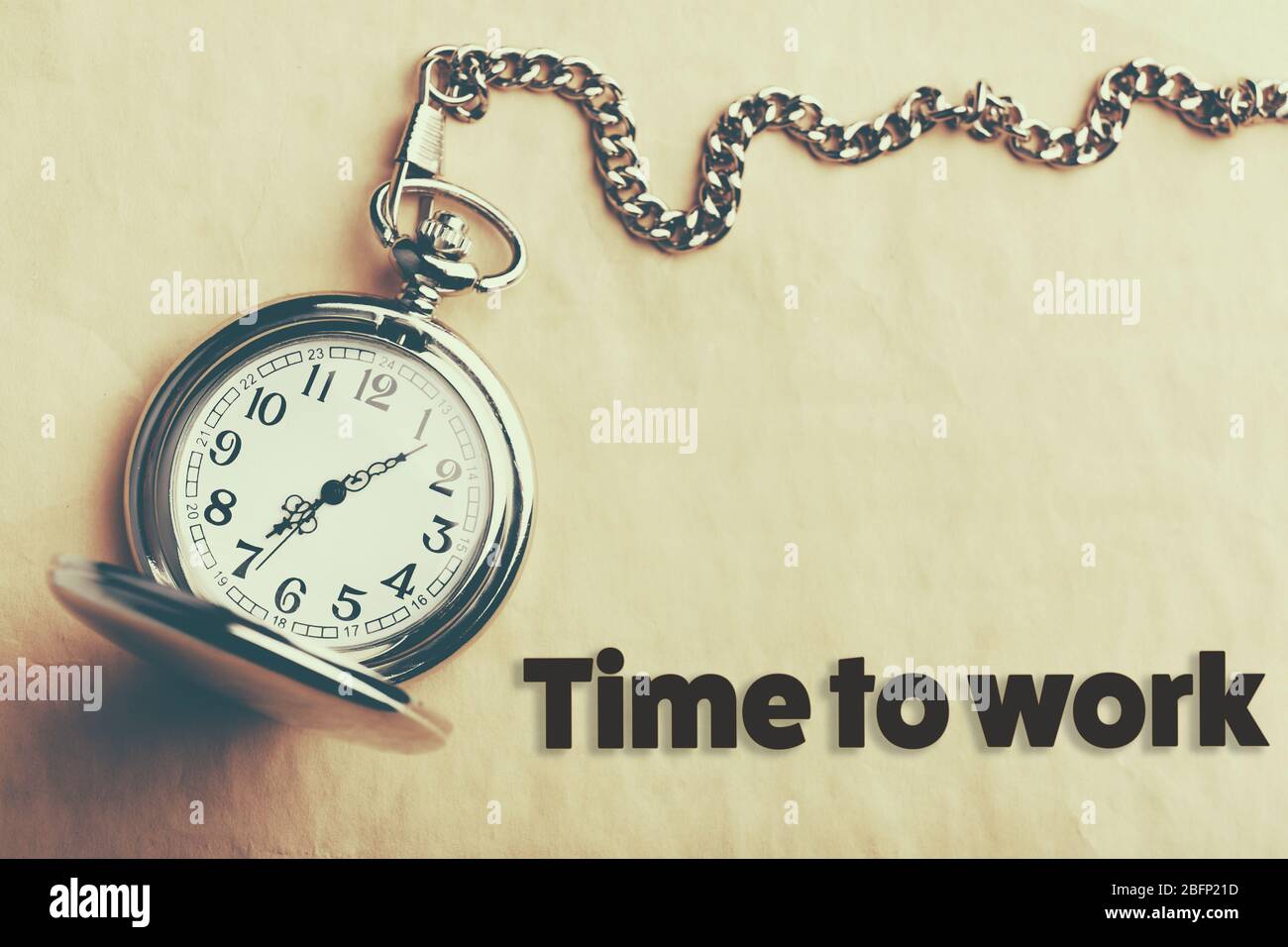 Silver pocket clock on old paper background Stock Photo - Alamy