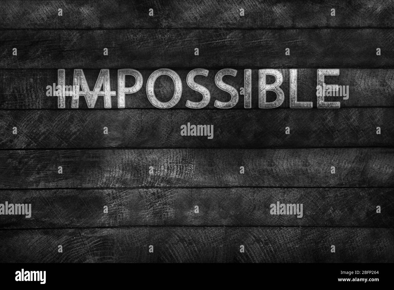 Word impossible transformed into possible on grey wall Stock Photo