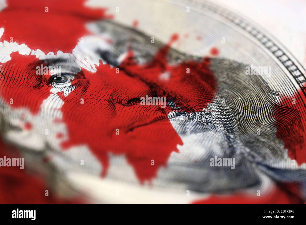 Dollar face and blood splashes close-up Stock Photo