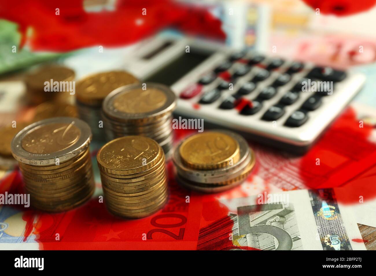 Grey calculator, banknotes and coins with bloodstains Stock Photo - Alamy