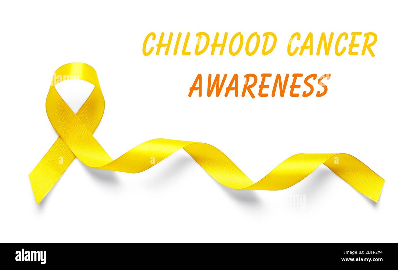 Yellow ribbon and text Childhood Cancer Awareness on light background Stock Photo