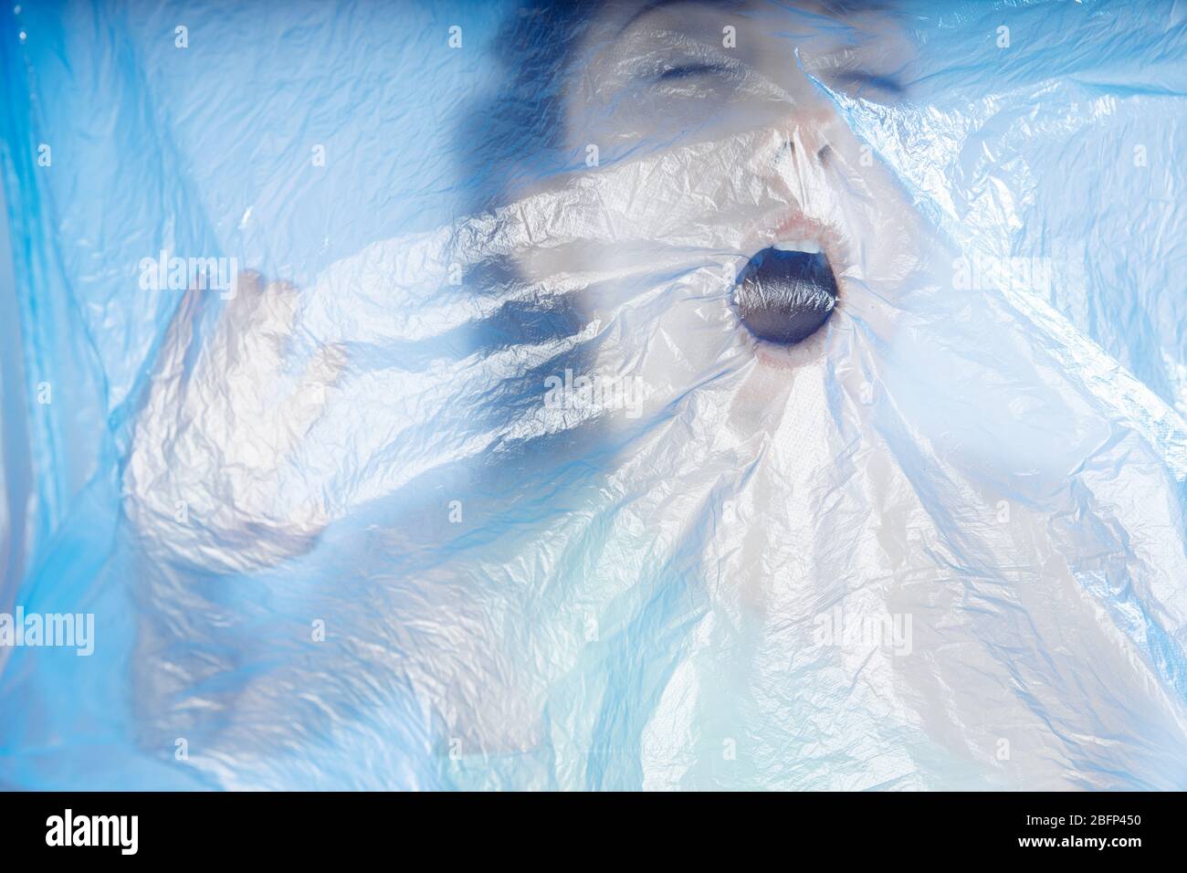 Plastic and makes it difficult to breathe. The girl's lips and mouth are covered with
