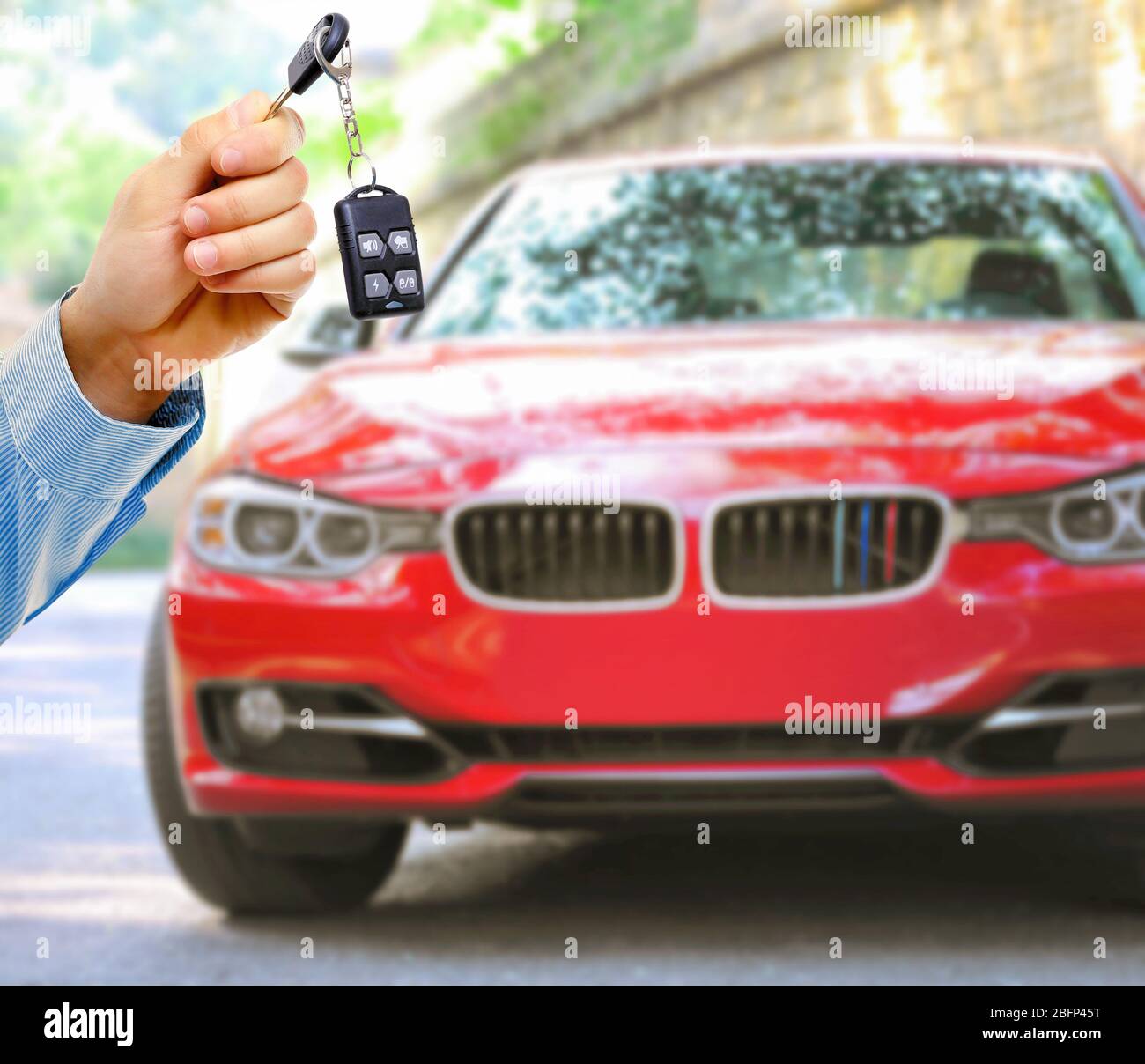 Businessman holding car key on blurred red car background Stock Photo ...