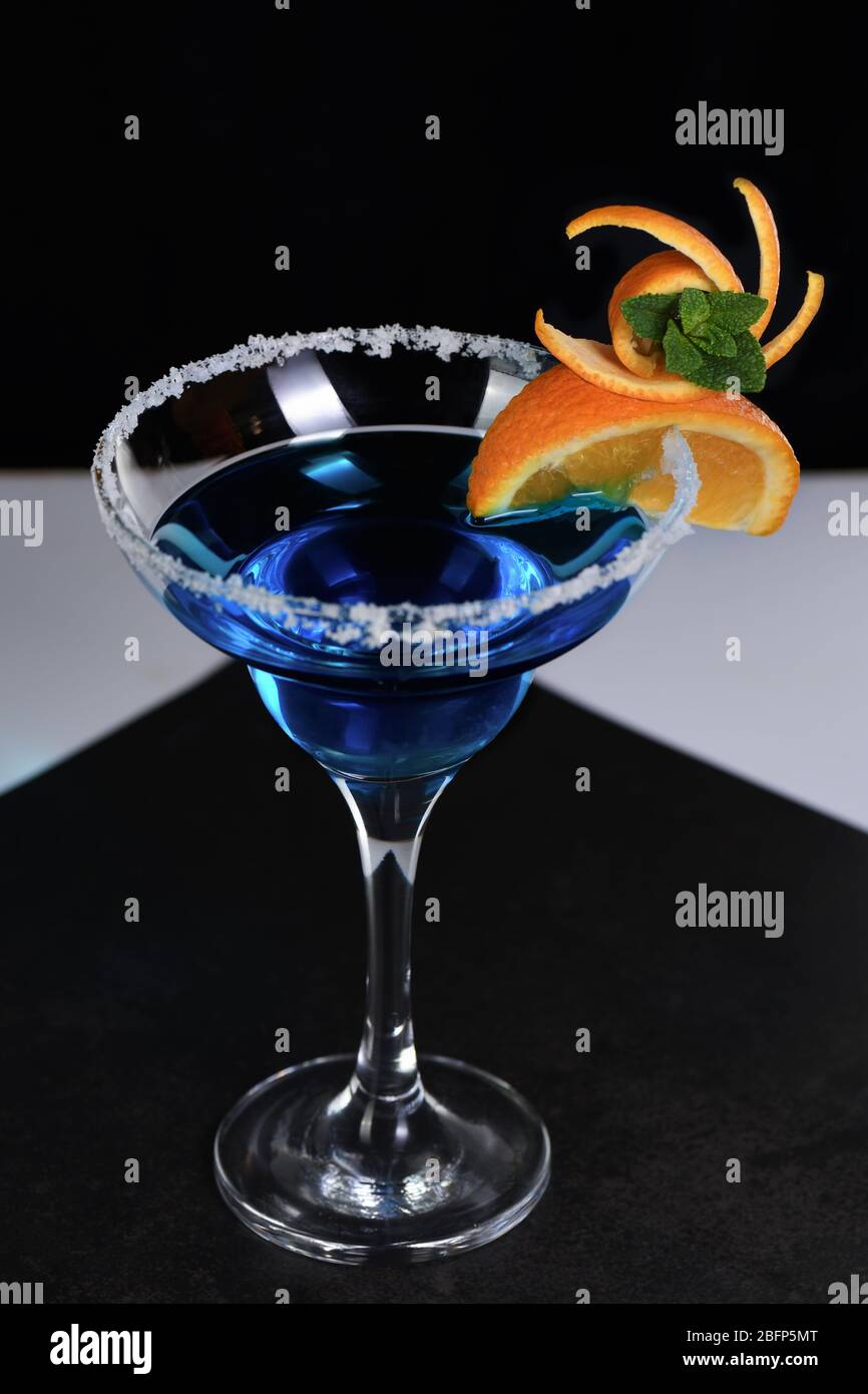 Art in orange- fruits carving. How to make to citrus garnish design for a drink. Cocktail Blue lagoon Stock Photo