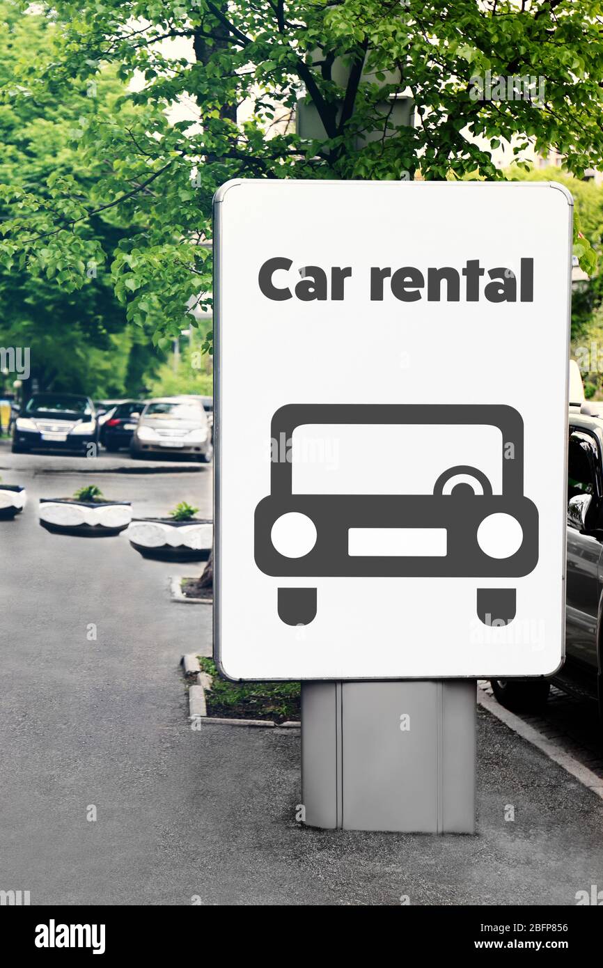 Billboard with text car rental on city street. Stock Photo