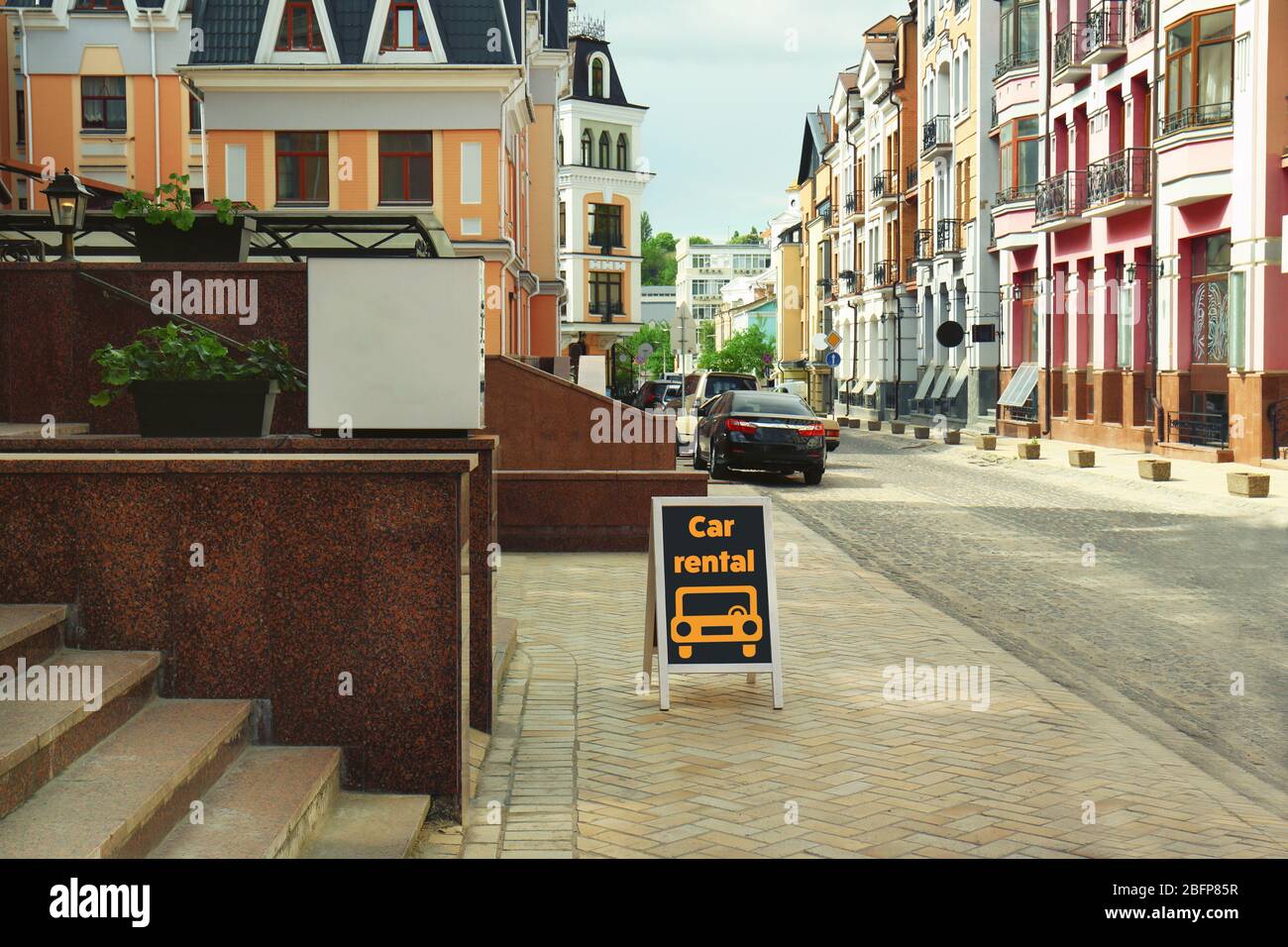 Billboard with text car rental on city street. Stock Photo