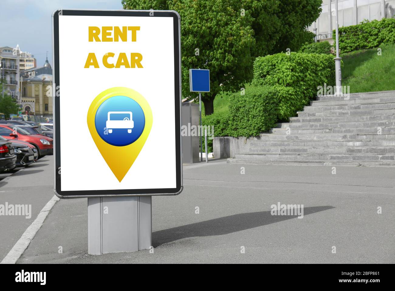 Billboard with text rent a car on city street. Stock Photo