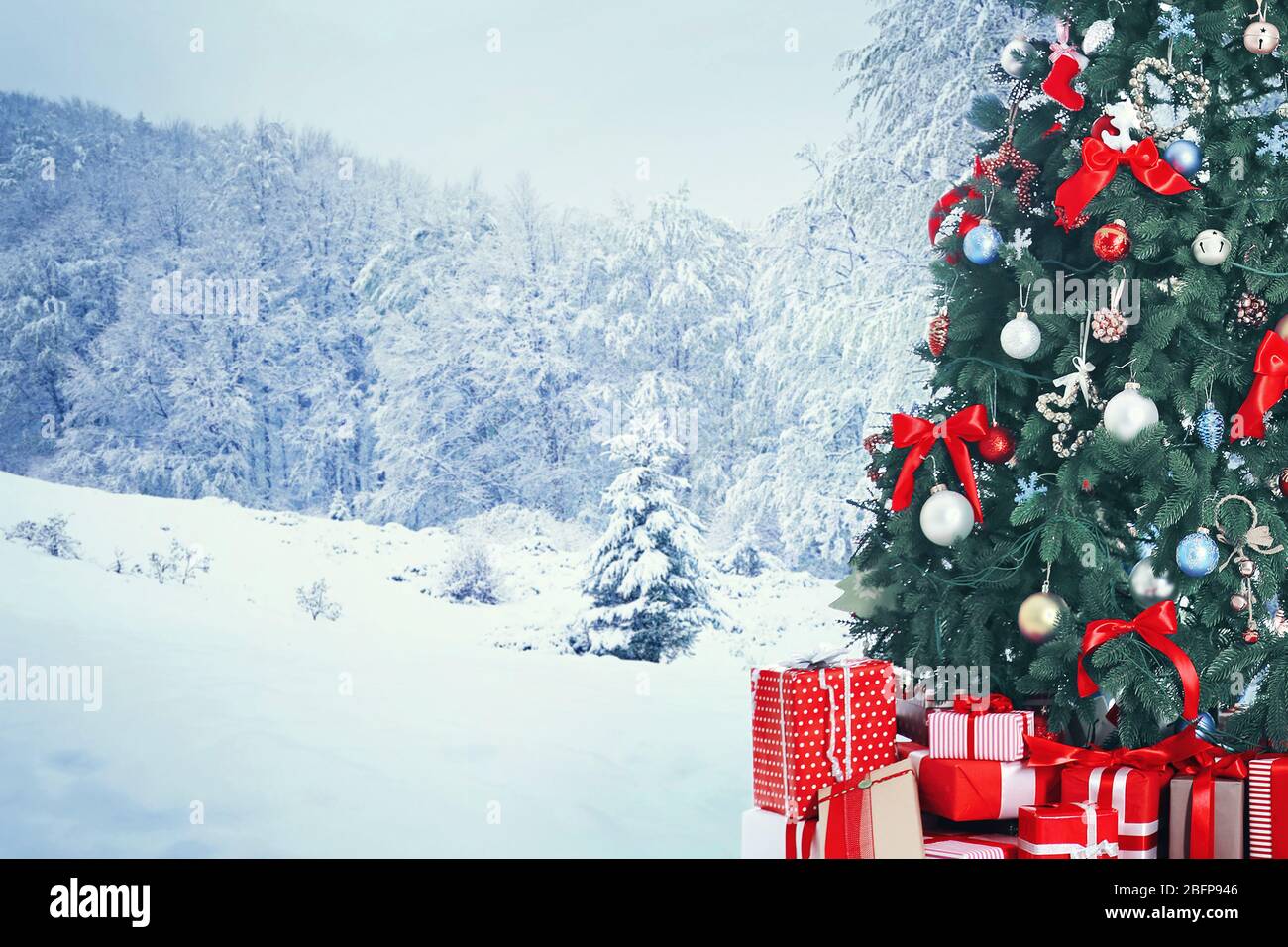 Decorated Christmas tree with gifts on nature background. Christmas ...