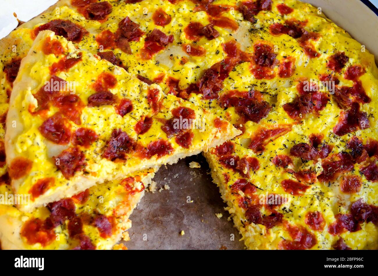 Delicious pizza with vegetables, ham, cheese, kashkaval and eeg  in tray, Sofia, Bulgaria, Europe Stock Photo