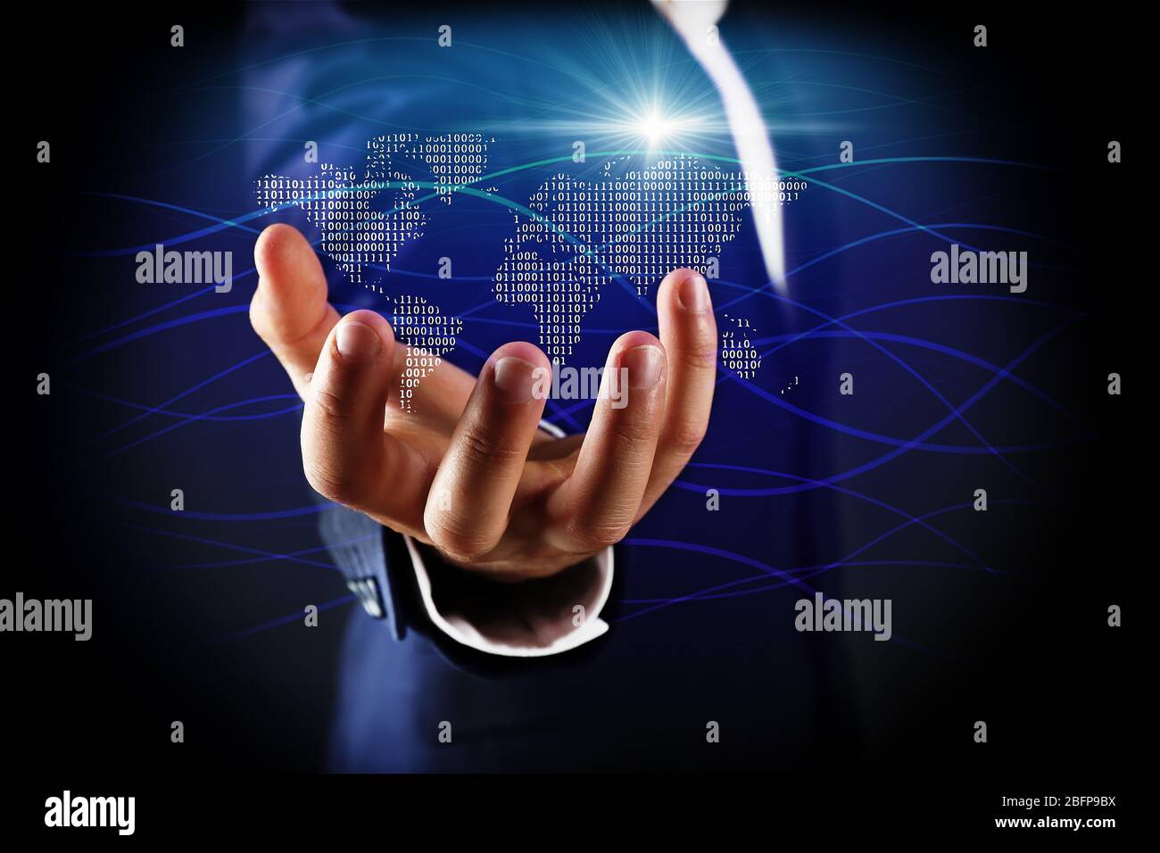 Businessman holding digital world map in hand. World map and binary code on digital display. Technology concept. Stock Photo