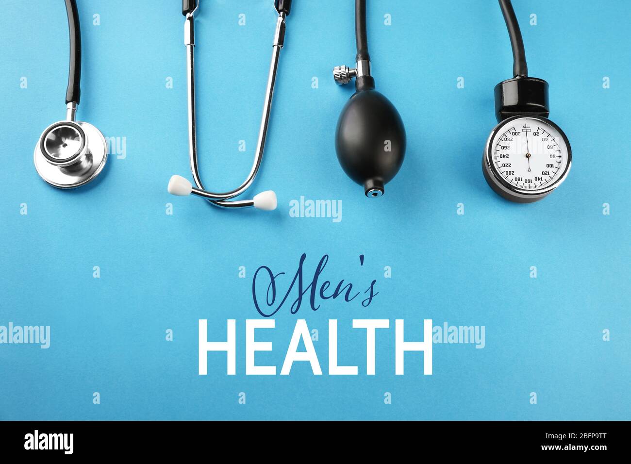 Medical manometer and a stethoscope on blue background. Urology concept