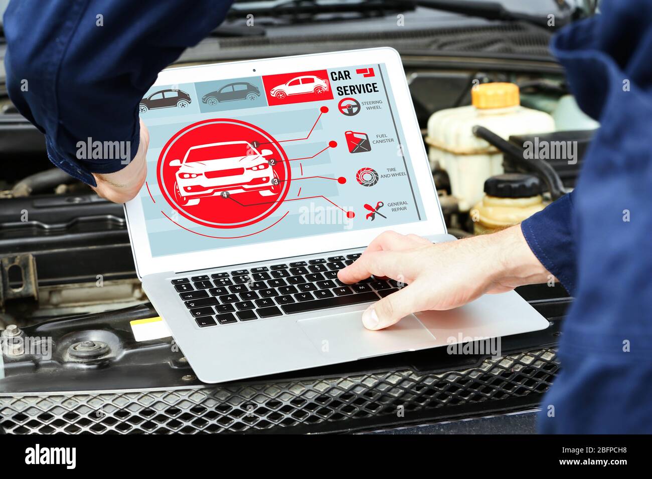 Mechanic with laptop near car engine. Modern car diagnostic program on