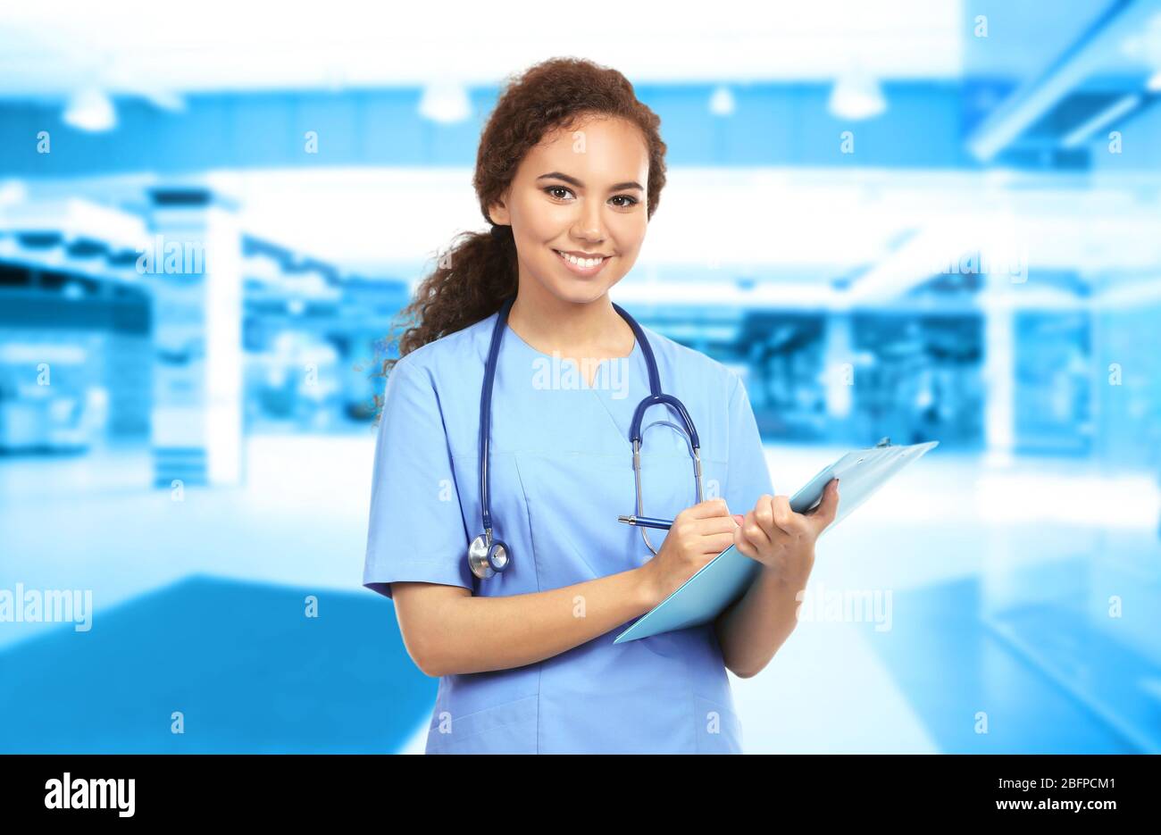 Young doctor on blurred hospital background. Medical service concept Stock  Photo - Alamy