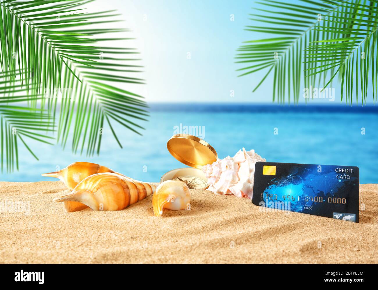 Travel concept. Credit card with seashells on landscape background Stock Photo