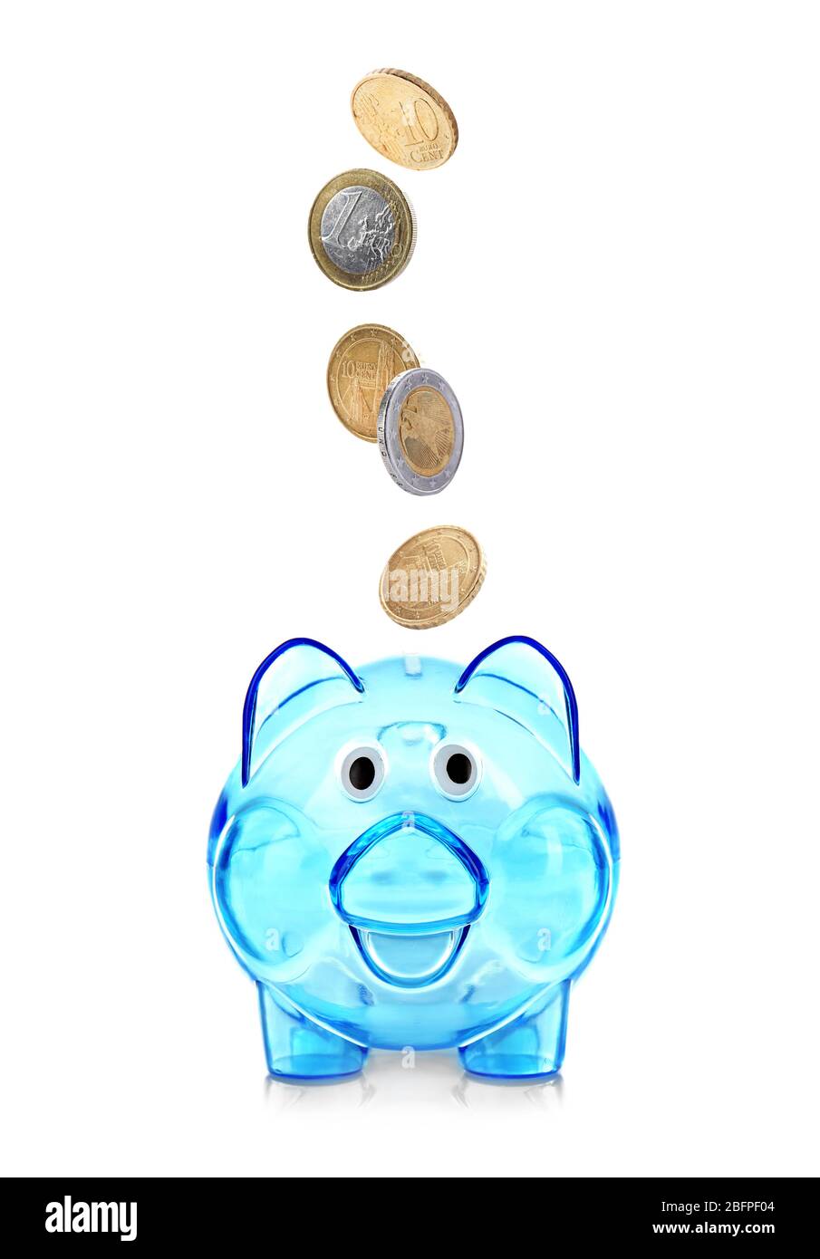 Coins falling into piggy bank on white background Stock Photo - Alamy