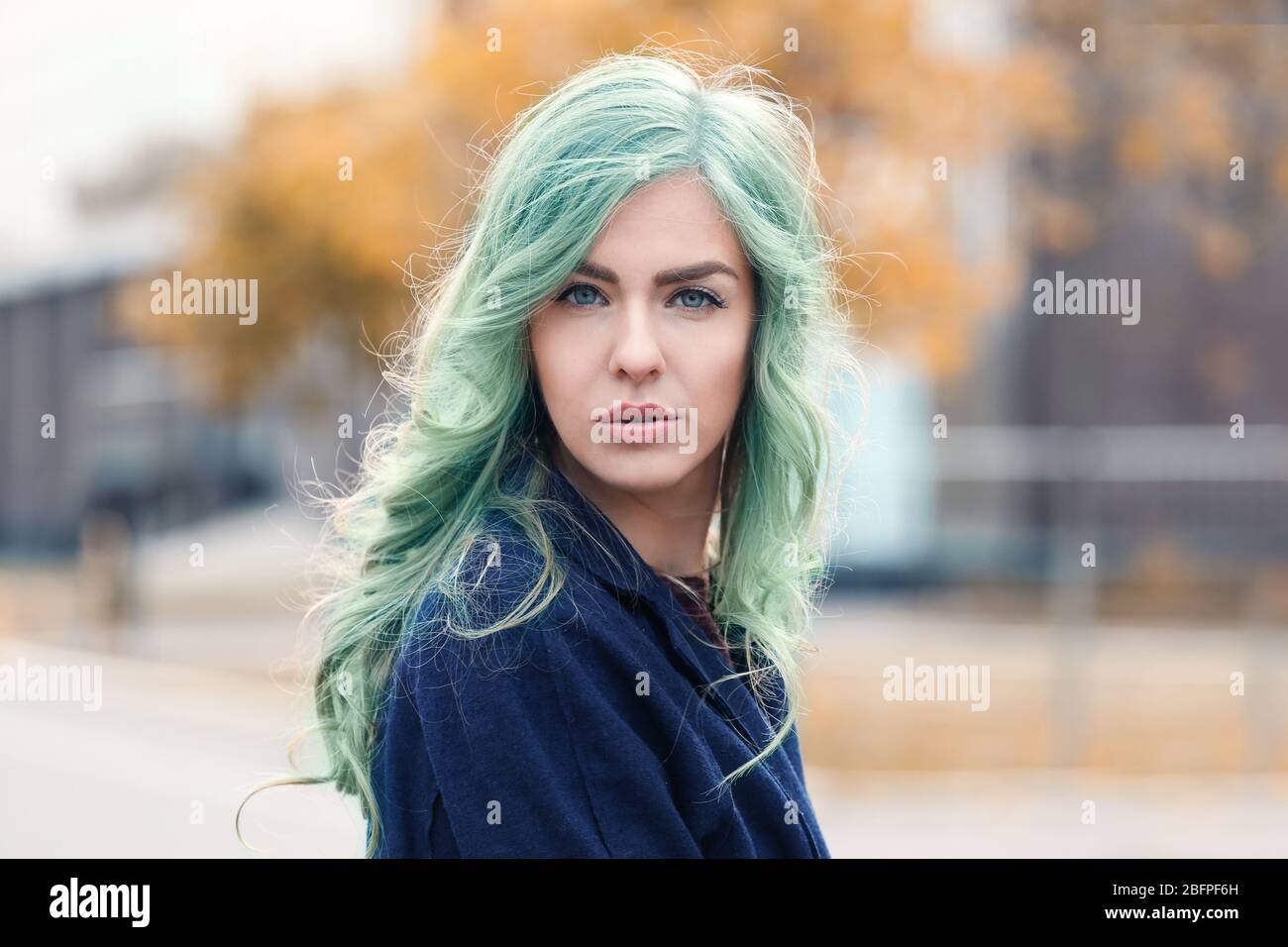 Trendy hairstyle ideas. Young woman with mint hair color on blurred  background Stock Photo - Alamy