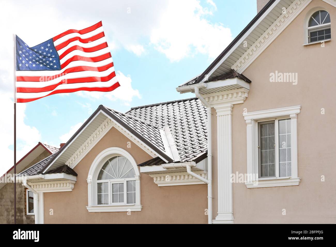 Us flag waving on house hi-res stock photography and images - Alamy